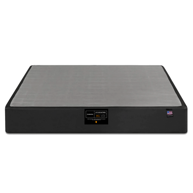 The My Cloud Mattress Foundation is a sleek black and gray rectangular base. It features a front label with text and logos, claiming its status as the greatest mattress base, all against a plain white background.