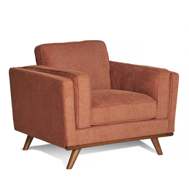 The Maddox Chair is a mid-century modern armchair with burnt orange upholstery, wooden tapered legs, and plush cushions on the backrest, seat, and wide armrests for stylish comfort.