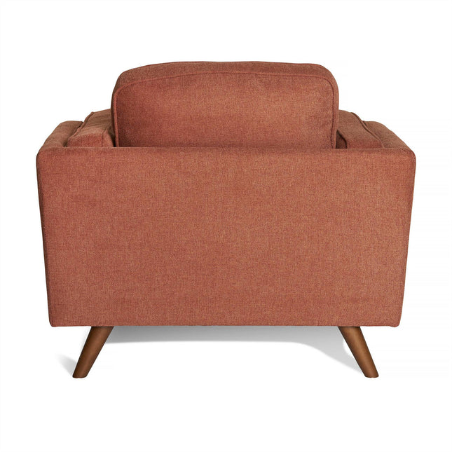 Viewed from the back, the Maddox Chair is a modern mid-century style armchair in rusty orange fabric. It boasts clean lines, plush cushions, and angled wooden legs with a dark brown finish, embodying a stylish retro aesthetic akin to the Maddox Sofa Set.