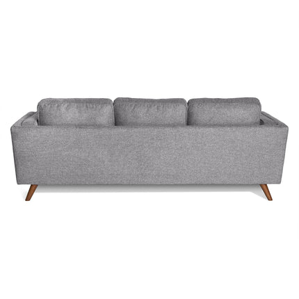 The Maddox Sofa has a gray upholstered back view with three plush cushions, showcasing mid-century modern design with slightly angled wooden legs. Its textured fabric pairs perfectly with its sleek, rectangular silhouette.