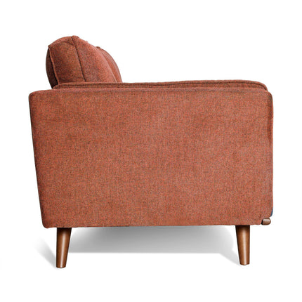 An orange upholstered armchair with a boxy shape and wooden legs, evoking mid-century modern style. It has plush back cushions and a simple, modern design that pairs perfectly with the Maddox Sofa against a white background.